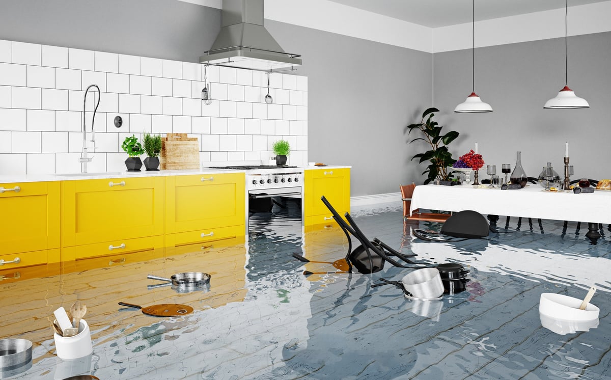 Flooded modern kitchen with standing water after a home water damage disaster.