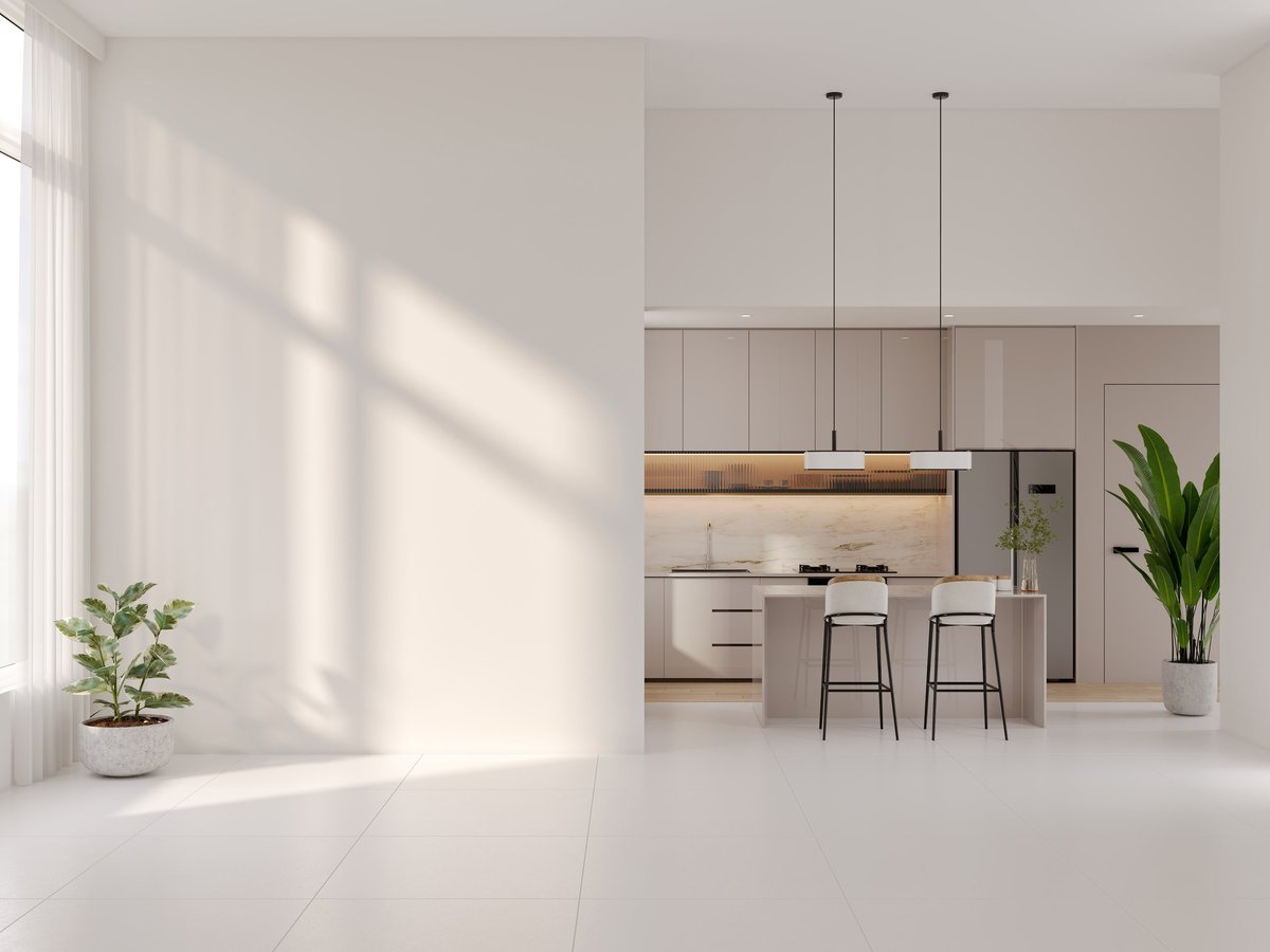 Freshly renovated empty apartment kitchen and open living space with clean finishes.